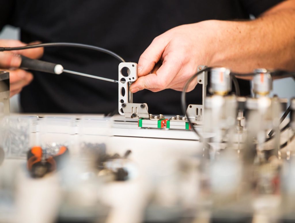 Boa 1087 Employee is working on a pharmacy robot piece